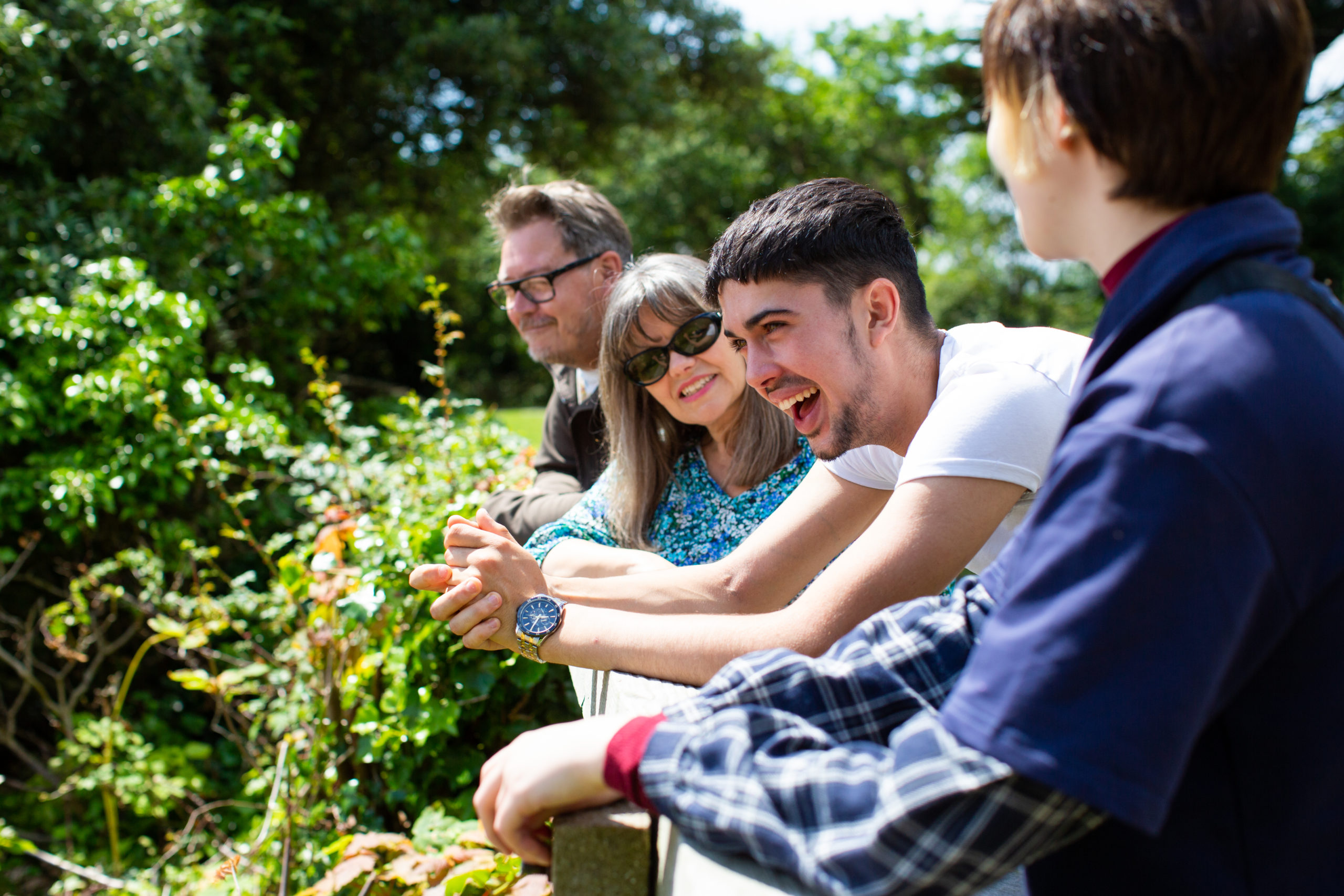 Family of four outside smiling