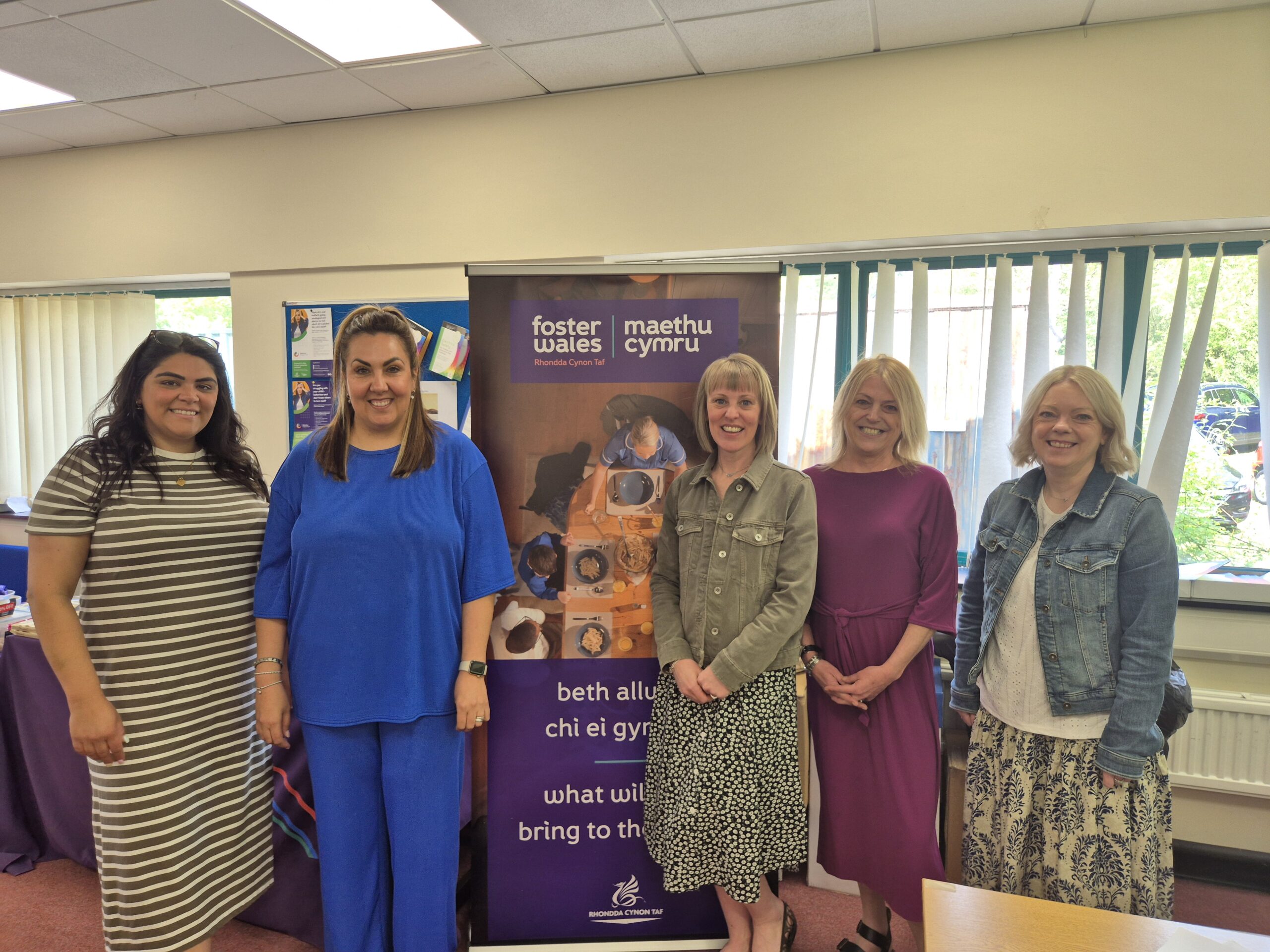 five female social workers smiling at camera